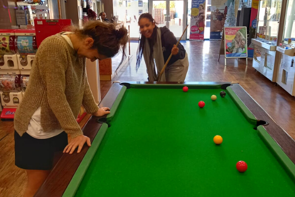 Andrea's family learn to play pool together on their holiday with Family Holiday Charity.