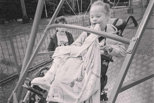 Erika's daughter, Evie, was playing on the swing in the park