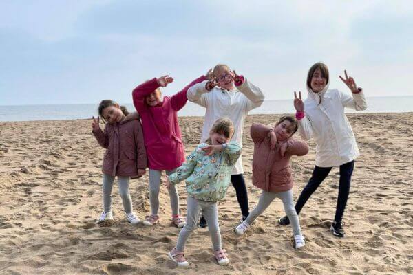 A photo taken by Kevin of her six daughters posing cutely together at the beach.