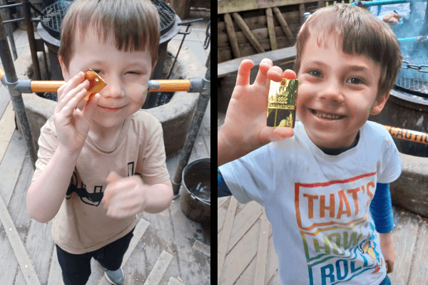 Elijah and Alistair posing happily with their souvenir golden keyring they made on their holiday. 