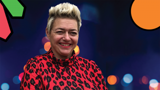 Dark navy rectangle with blurry christmas lights dotted along the background, a smiling Karen sat next to them.