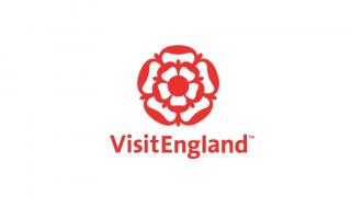 Logo of VisitEngland. Shows a graphic of a large red rose with the text Visit England beneath it.