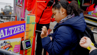Child queueing for ride at funfair