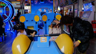Two children playing on a VR arcade game