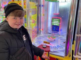 boy infront of arcade machine