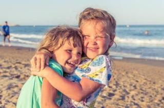 children hugging on the beach