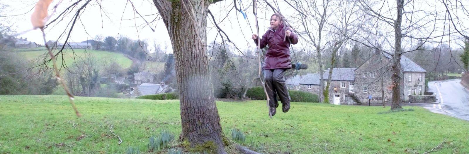 Helen's daughter swings on a tree swing on her family holiday with Family Holiday Charity