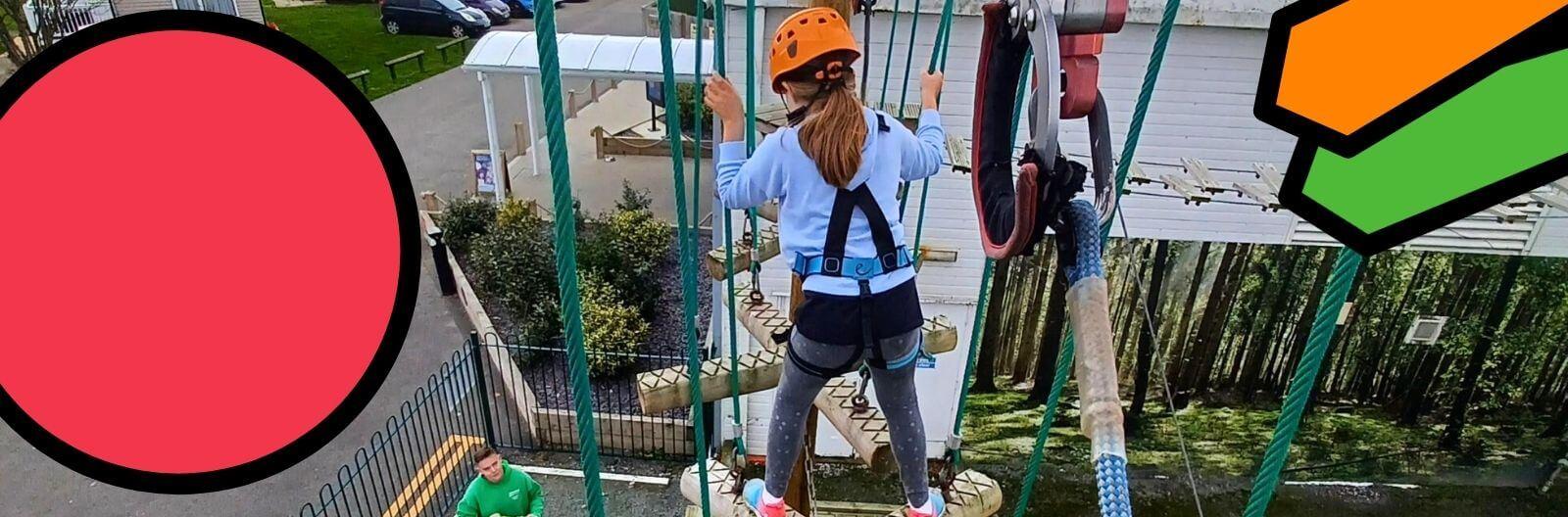 Maria's daughter Lucy takes part in the high wires. Lucy is securely strapped in whilst an instructor guides her from the ground.