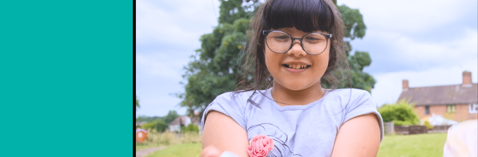 Chris's daughter, Pixie, holding a tiny ball smiling happily into the camera.