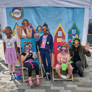 Six ladies posing in front of our pop-up booth in Eastbourne.