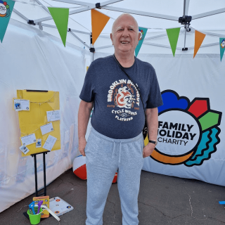 A man standing in our pop-up booth smiling happily.