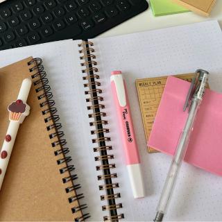 Notebook, post-its notes and pen on a planner journal
