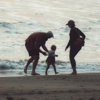 family play on the beach