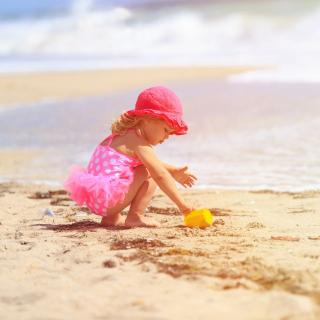 Young girl playing in the sand