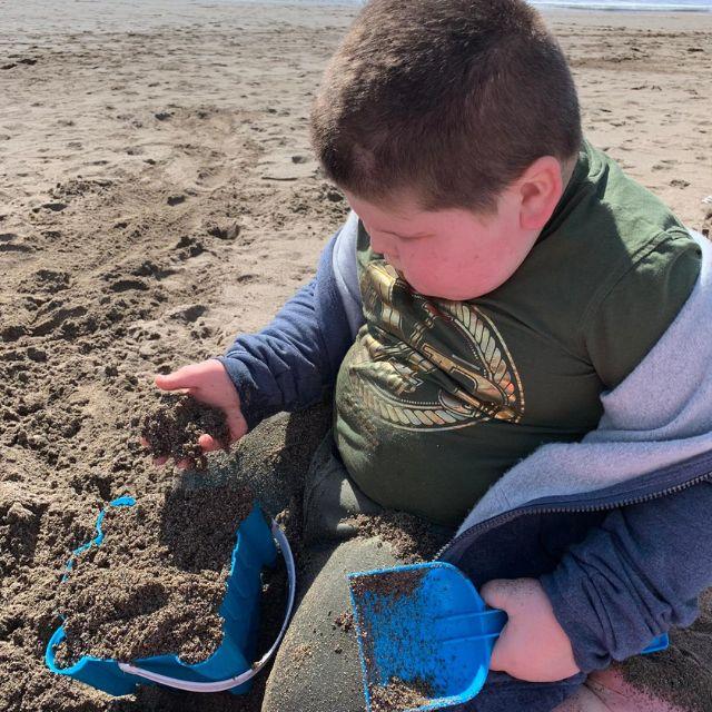 Adrian's son Rhys plays in the sand on his family holiday.