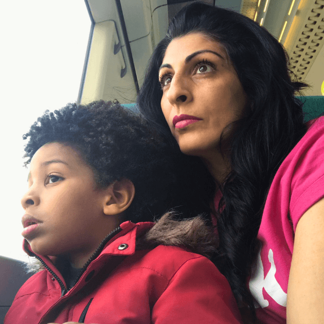 Mum, Sabina, and her son Dion sit on the train looking out of the window on their way to their holiday.