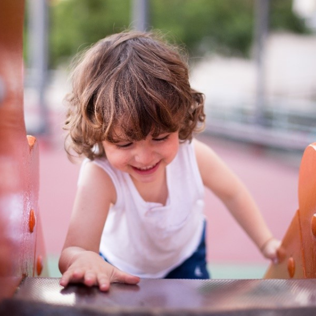 A boy is climbing up a slide