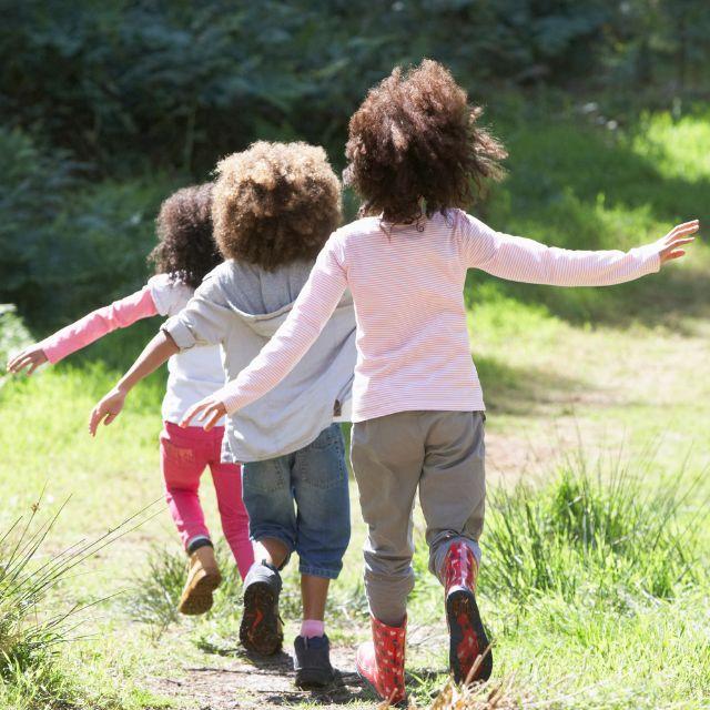 Children running outside in a field