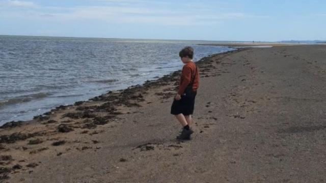 Sharon's son playing on the beach during their family holiday.