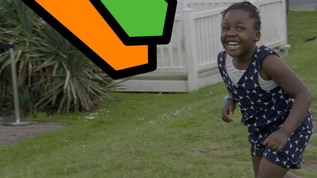 Abi's daughter, Loveina, runs through the green grass of the holiday park with a huge grin on her face on her first family holiday